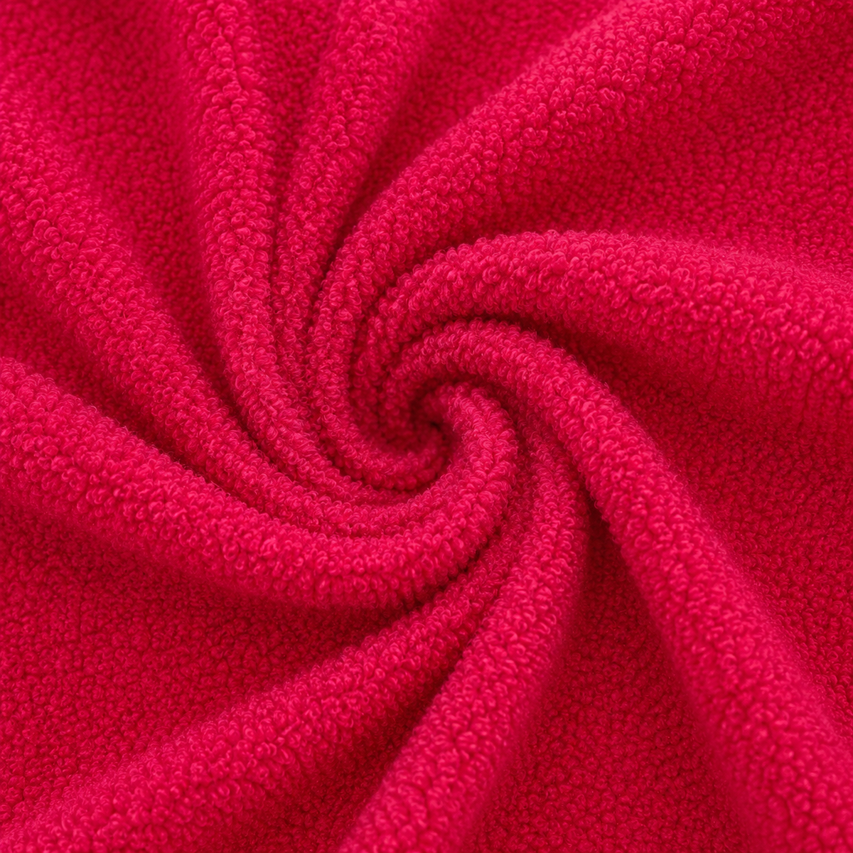 A close-up of bright pink fleece fabric swirled in a spiral pattern, showing the soft textured material filling the frame.